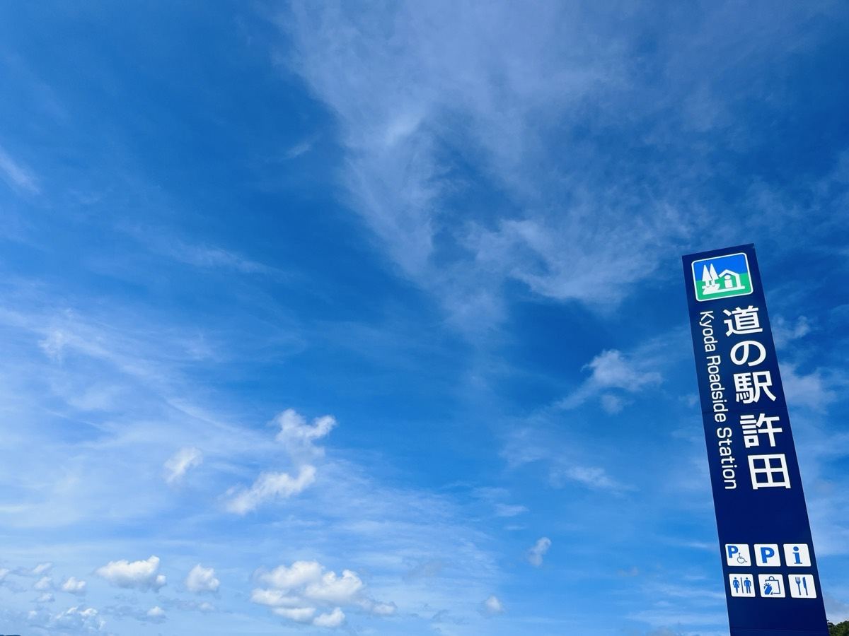 青空にのびる道の駅許田の縦型の案内標識